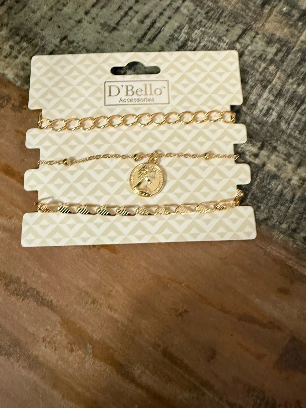 Set of 3 D’Bello packaged gold toned bracelets.